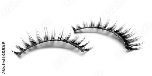 Beautiful pair of false eyelashes on white background