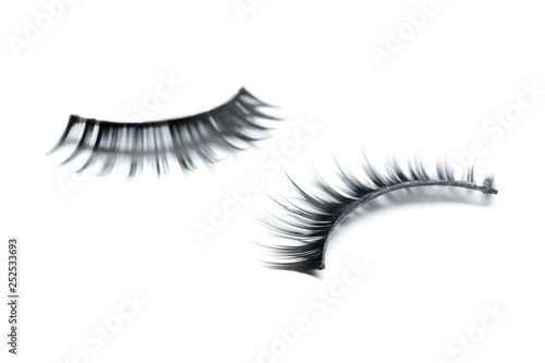 Beautiful pair of false eyelashes on white background