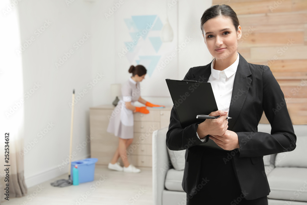 Housekeeping manager checking maid work in hotel room Housekeeping manager checking maid work in hotel room