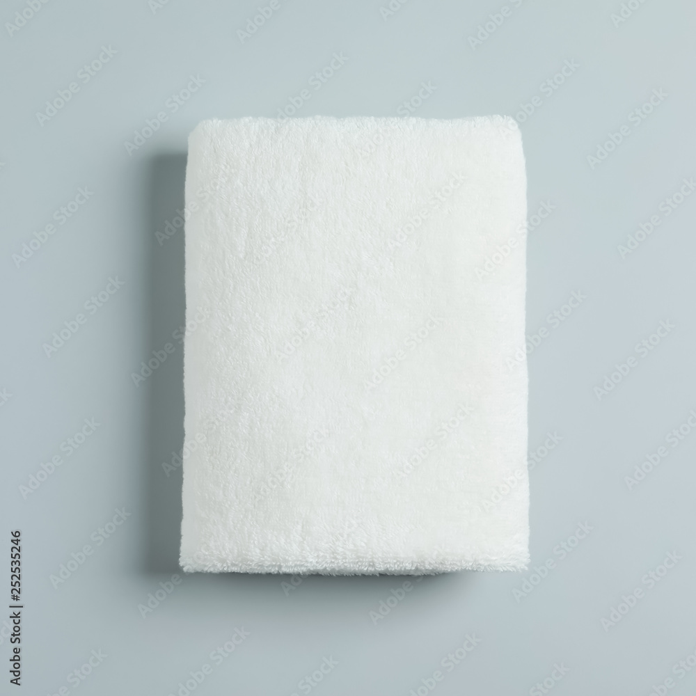 Fototapeta premium Soft folded towel on light background, top view
