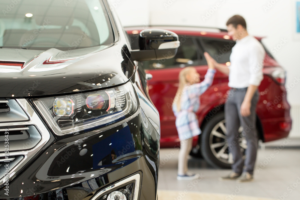 Father and daughter at the car dealership Father and daughter at the car dealership
