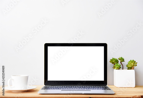 blank screen Modern laptop computer with mouse,Smart phone and Succulent on wood table in office view backgrounds