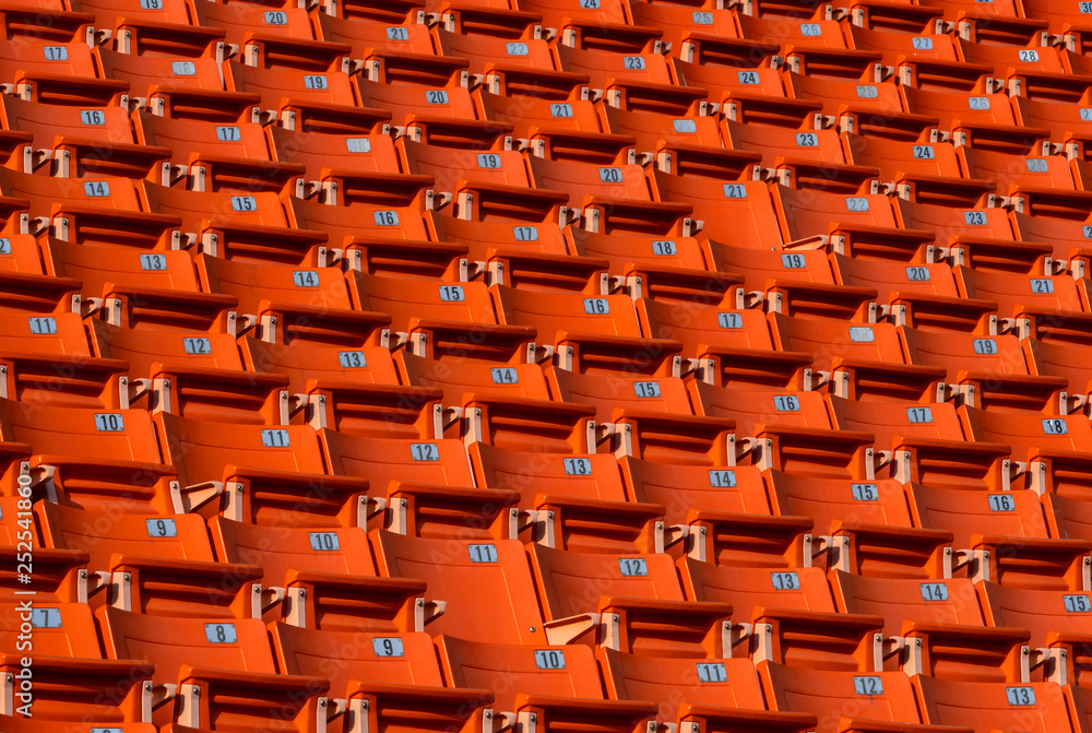 Fototapeta premium Orange stadium seat row with number