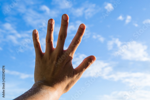 hand in sky holding something