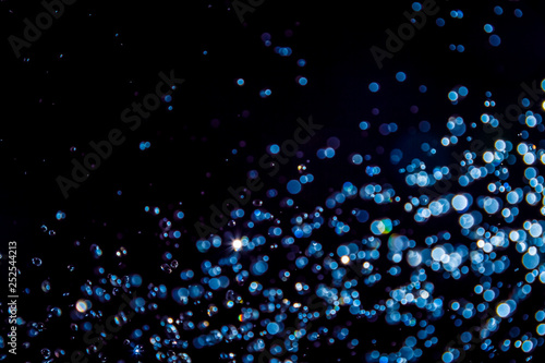 Luxurious Blue bokeh texture on black © pandaclub23