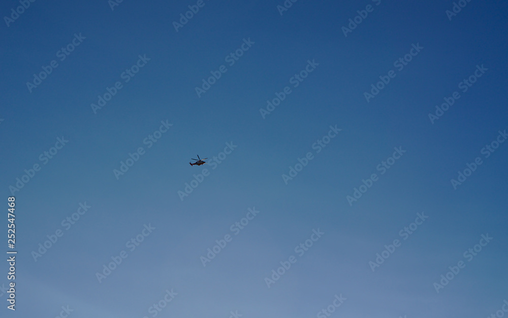 Helicopter flying with blue sky background
