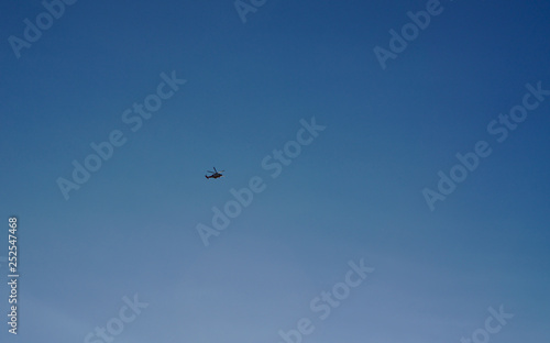 Helicopter flying with blue sky background