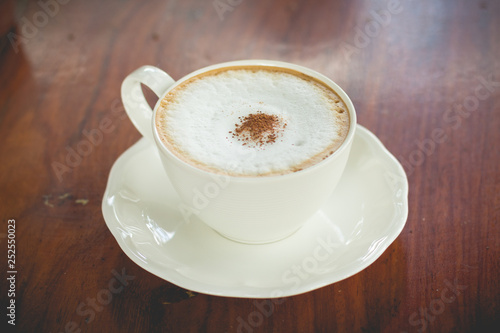 hot coffee mocha with foam milk in vintage cafe(vintage effect)