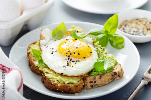 Fotografie Avocado toast with fried sunny side up egg