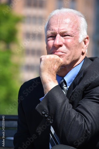 Adult Senior Businessman Making A Decision Wearing Suit And Tie Sitting
