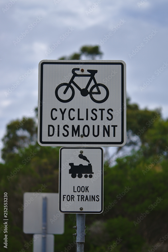 Cyclists dismount Look for trains sign