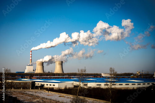 Industrial factory smoke stack of coal power plant from chimney up on sky cause air pollution and destroy the Earth's atmosphere.