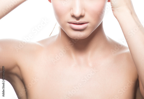 Lips, neck and shoulder of beauty model girl. Natural nude make-up, clean skin. Part of woman face. White background. Skincare facial treatment concept