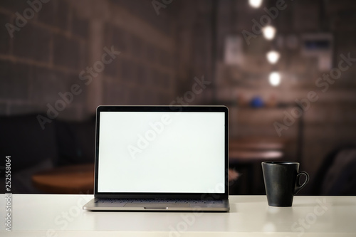 Wallpaper Mural Mockup Laptop Computer and Coffee on cafe at night time. Torontodigital.ca