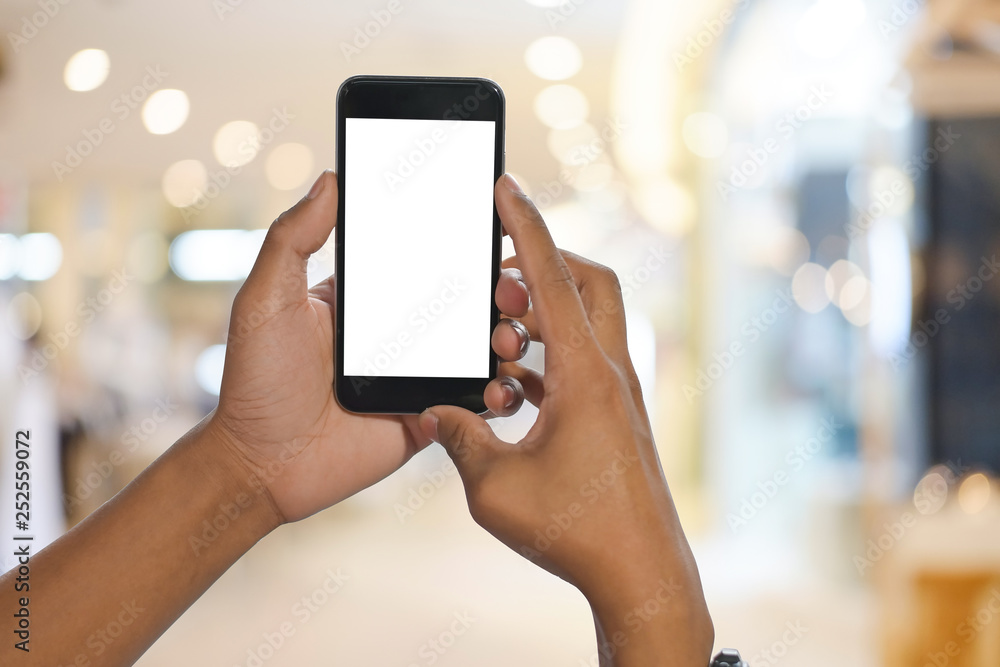Cropped shot view of man hands holding smart phone with blank copy space screen for your text message or information content. Cropped shot view of man hands holding smart phone with blank copy space screen for your text message or information content.