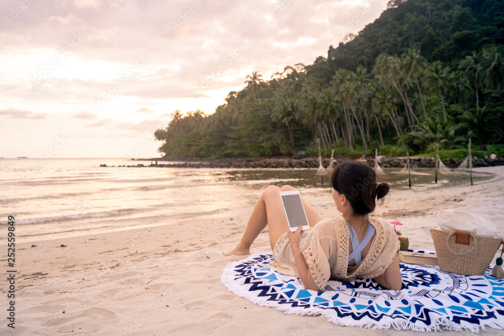 Woman is reading a book on beach