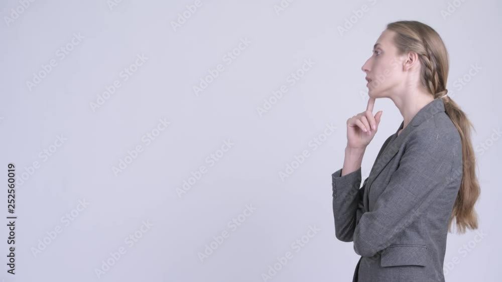 Profile view of happy young blonde businesswoman thinking Profile view of happy young blonde businesswoman thinking