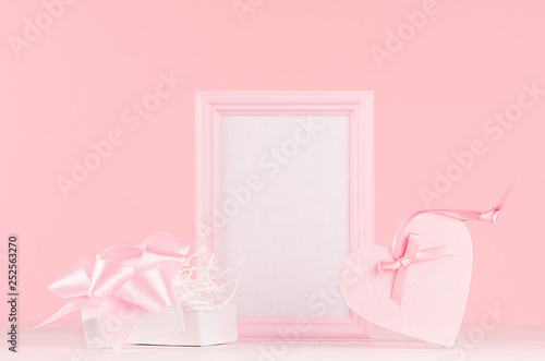 Modern fashion Valentine days background - trendy pink heart with ribbon, present and blank frame for text on white wood board.