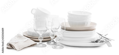 Set of white ceramic dishes and shiny glasses