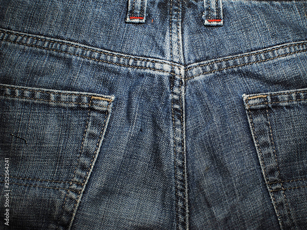 Old faded blue jeans. Macro. Pocket on old blue jeans. Old faded blue jeans. Macro. Pocket on old blue jeans.