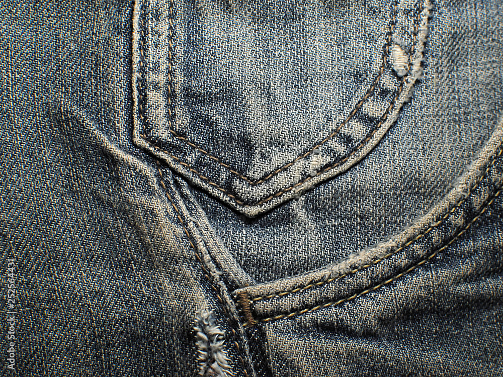 Old faded blue jeans. Macro. Pocket on old blue jeans. Old faded blue jeans. Macro. Pocket on old blue jeans.