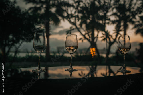 glasses of wine on the table against the background of sunset in Vietnam