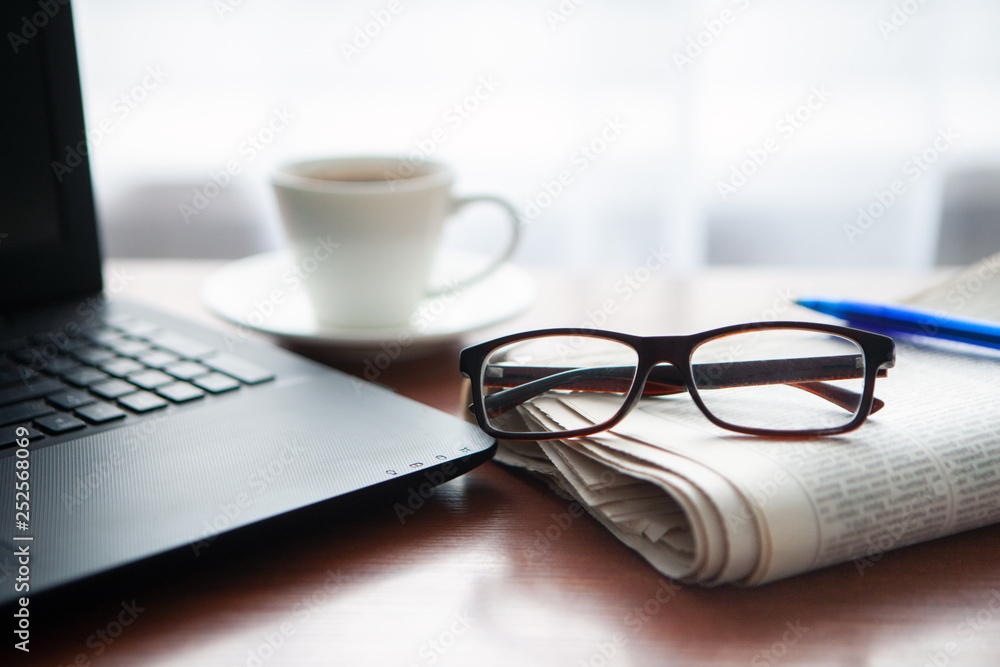 Newspaper with computer on table. Coffee break. Newspaper with computer on table. Coffee break.