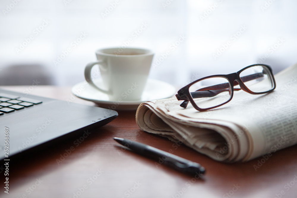 Newspaper with computer on table. Coffee break. Newspaper with computer on table. Coffee break.