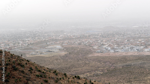 Breezy and Hazy Day Overlooking a Scenic Small Town from the Mountains