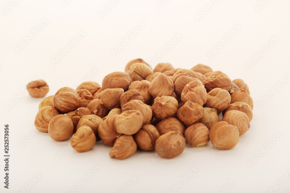 A pile of hazelnuts at white background A pile of hazelnuts at white background