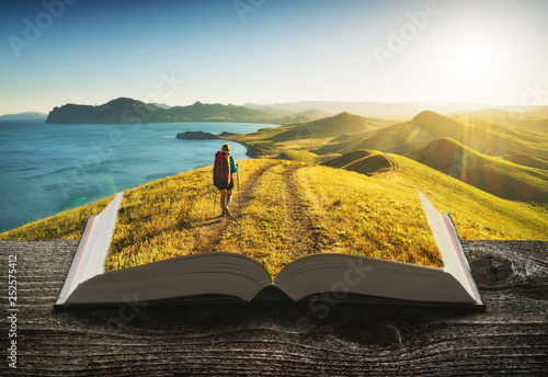 Girl hiker on the pages of book photo