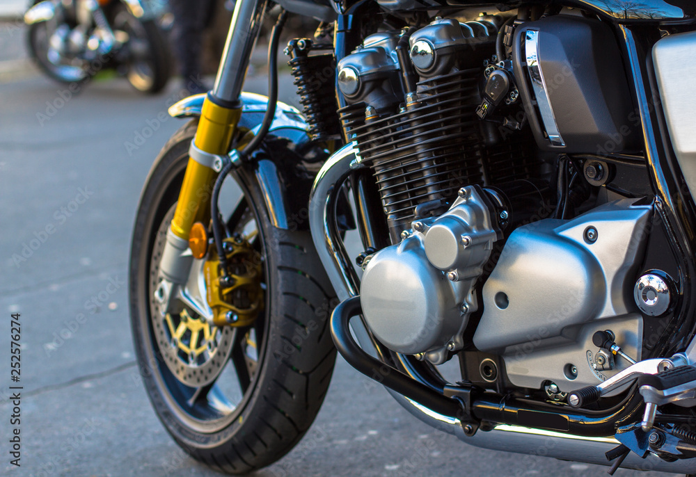 Shiny chrome motorcycle engine and forward tyre wheel