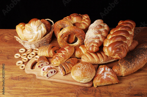 Bakery products on a wooden table on a dark background.