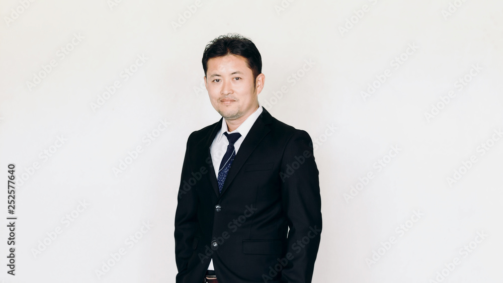 Young businessman looking thoughtfully at the camera over a white studio background with copy space Young businessman looking thoughtfully at the camera over a white studio background with copy space