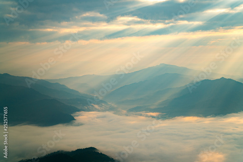 Fog over the valley mountain in morning lights.