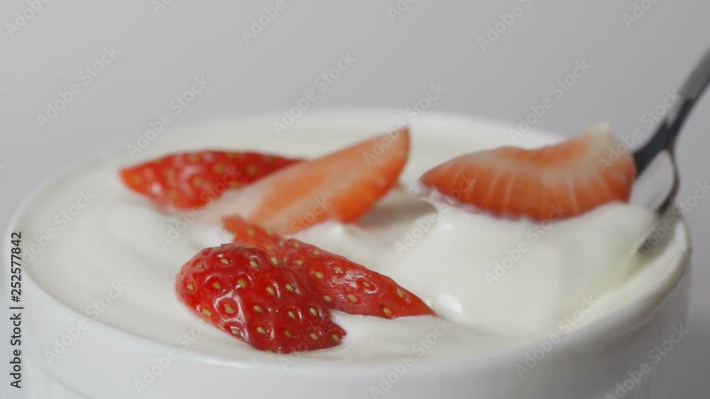 Slow motion of eating strawberries with cream with spoon. Slow motion of eating strawberries with cream with spoon.