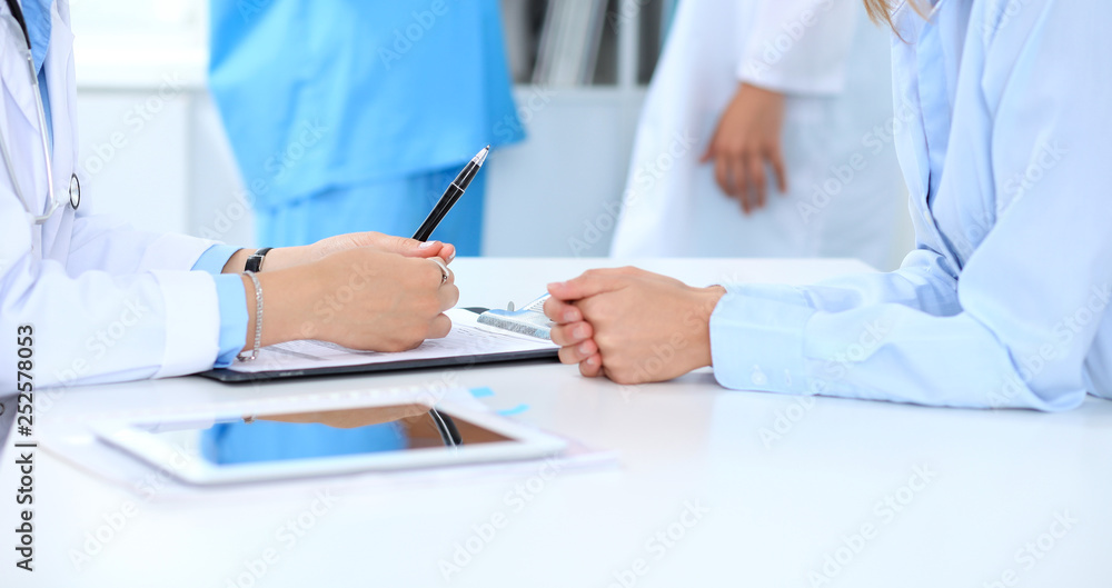 Doctor and patient discussing something, just hands at the table, white background Doctor and patient discussing something, just hands at the table, white background
