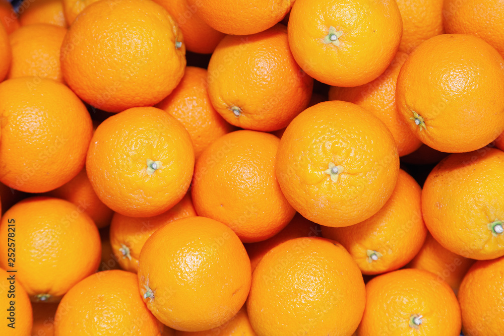 Many tasty ripe orange mandarins are piled on counter at the farmers market. New Year fruit concept, fresh squeezed vitamin juice, healthy foods Many tasty ripe orange mandarins are piled on counter at the farmers market. New Year fruit concept, fresh squeezed vitamin juice, healthy foods