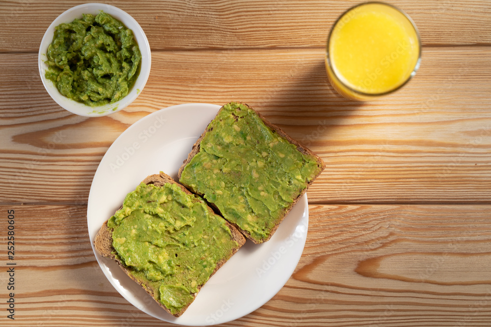 Toasts with avocado guacamole. Diet breakfast. Delicious and healthy plant-based food. Toasts with avocado guacamole. Diet breakfast. Delicious and healthy plant-based food.