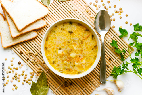 Soup from green lentils and soft cream cheese, seasoned with a mixture of peppers, laurel, with the addition of lowered grated carrots and finely chopped onions.