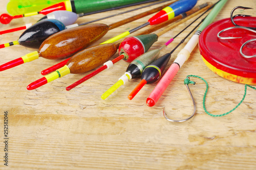 Fishing floats and fishing gear on a wooden table.