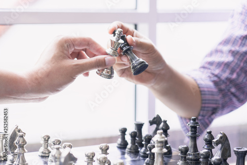 Hand of businessman moving chess figure . strategy, chess board game for ideas and competition and strategy,