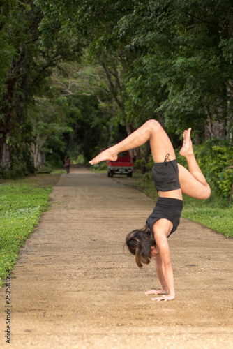Filipino girl yoga posing in tropical jungle rice fields