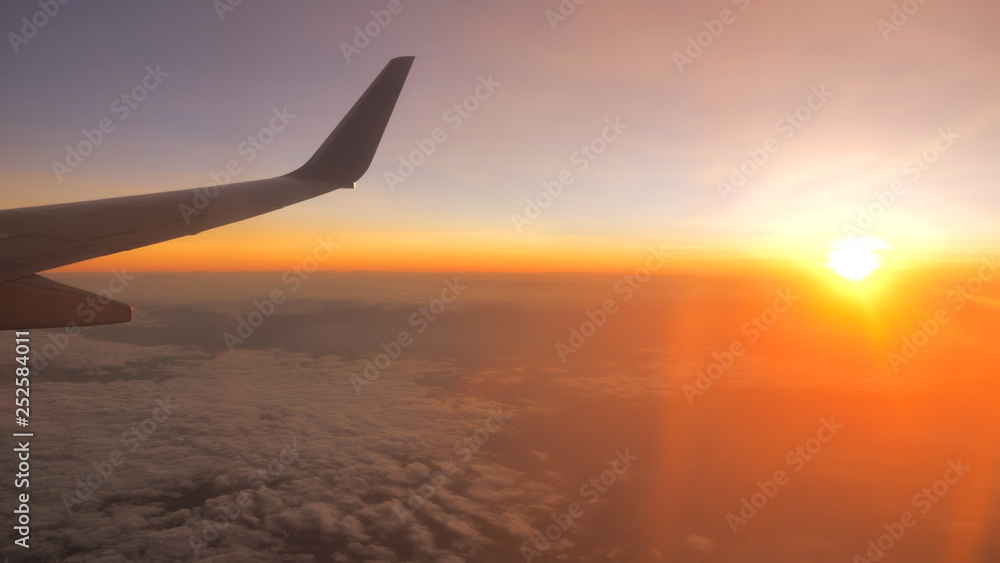 Fototapeta premium Sunset time Above the clouds.Wing aircraft on the sky