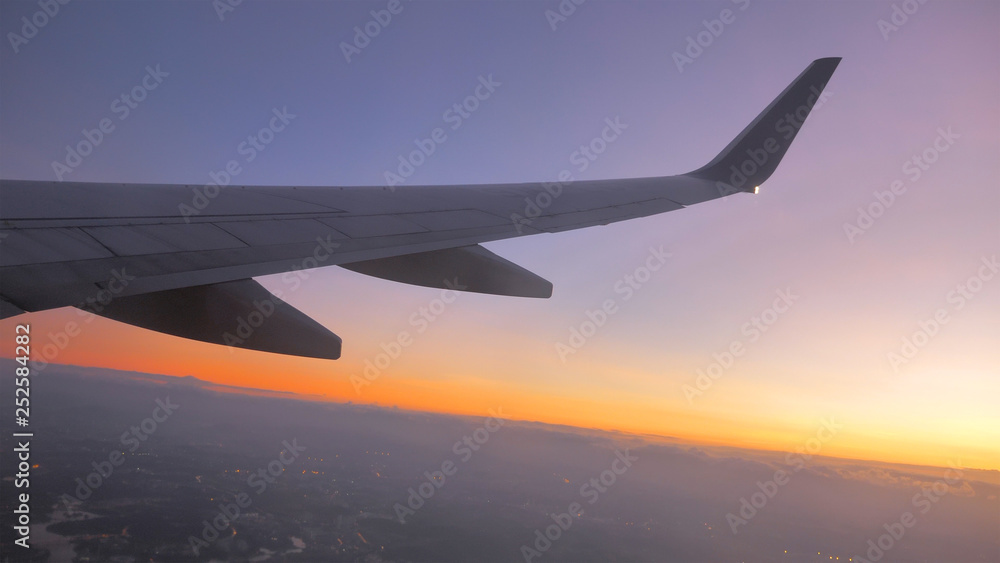 Fototapeta premium Sunset time Above the clouds.Wing aircraft on the sky