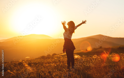 Happy woman jumping and enjoying life  at sunset in mountains. Fototapet