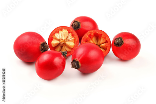 Fotografie Rosehips ( Rosa Canina fruits ) , one cut in half, isolated on white background