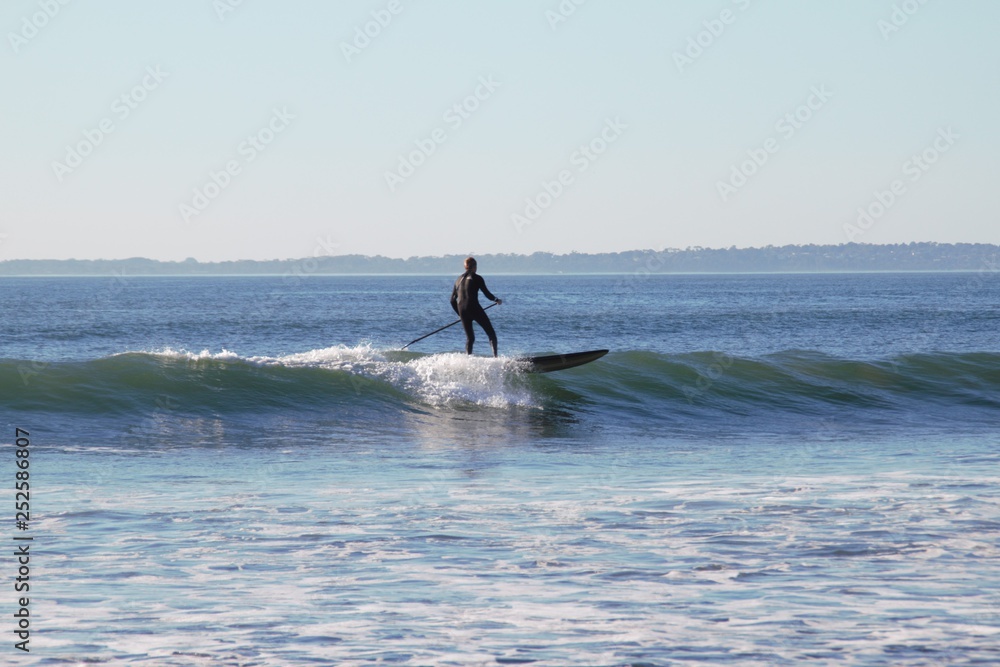 Lonely surfer in the Australian ocean 