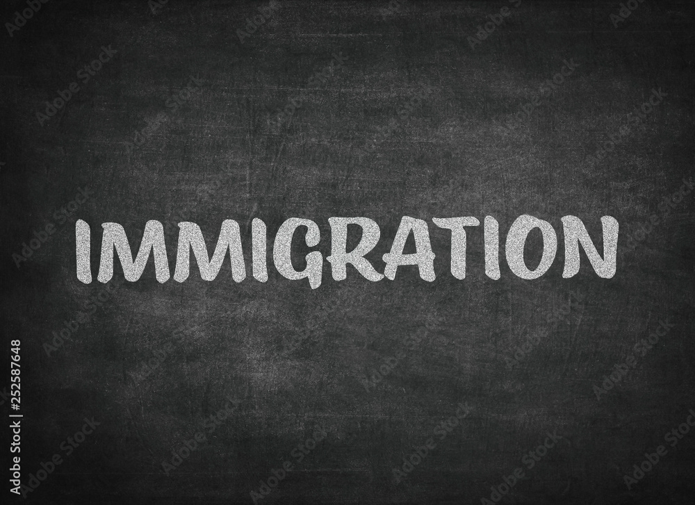Obraz premium immigration concept word on a blackboard background