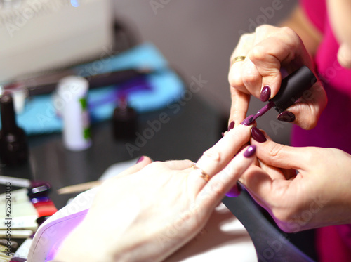 manicure in the salon. Coating gel varnish photography close-up.